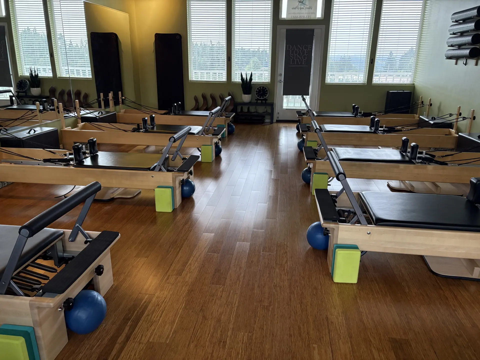 Rows of reformers facing each other in the SLOW burn Pilates studio